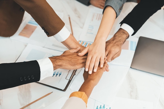 Top view of corporate diverse businesspeople putting hands together Ornamented