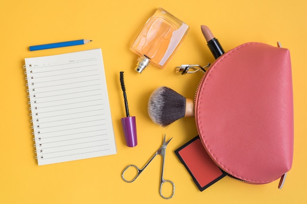 Top view of cosmetic bag with makeup items