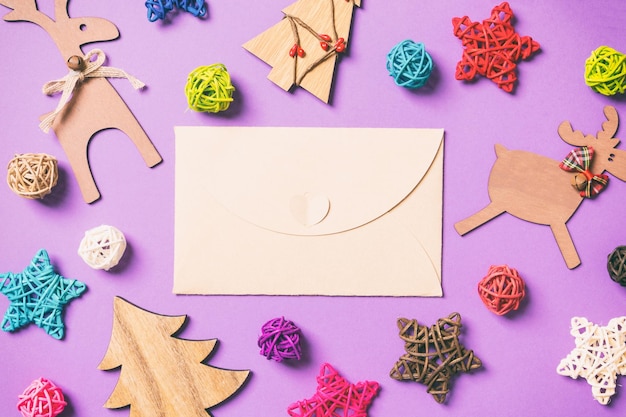 Photo top view of craft envelope new year decorations festive stars and balls merry christmas concept