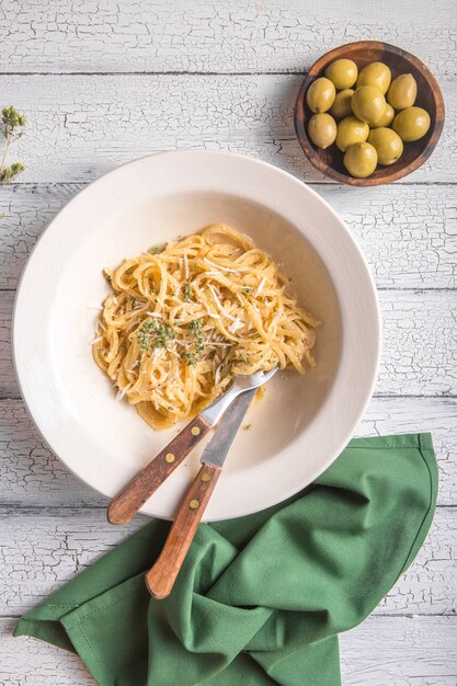 Top  view of Creamy  cheese , olives, Fettucini Alfredo pasta.