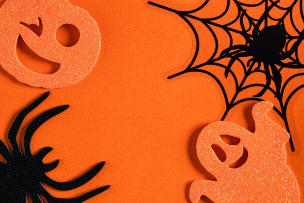 Top view of creative Halloween concept decoration on orange paper table background.