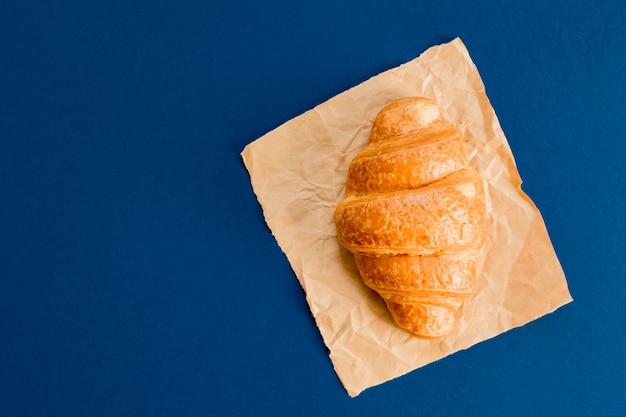 Top view of croissant on craft paper