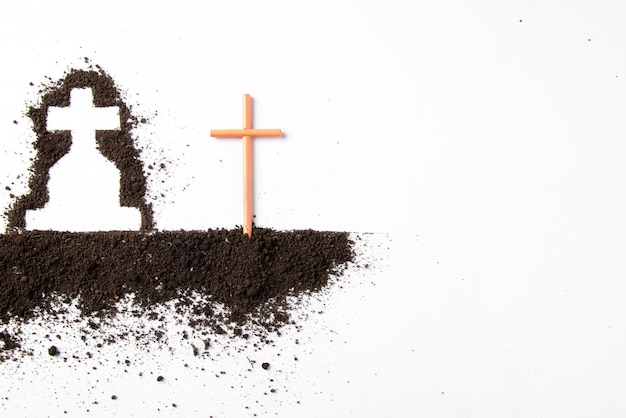 top view of cross shape with dark soil on white wall