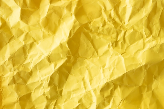 Photo top view crumpled yellow paper