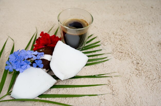 Photo top view cup coffee with coconut on the beach