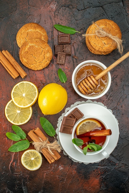 top view cup of tea with biscuits on dark background color morning sweet fruit ceremony tea