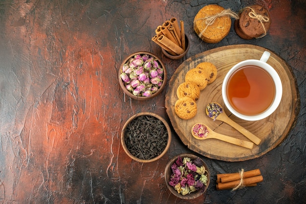 top view cup of tea with biscuits and flowers on dark background flavor color photo tea coffee