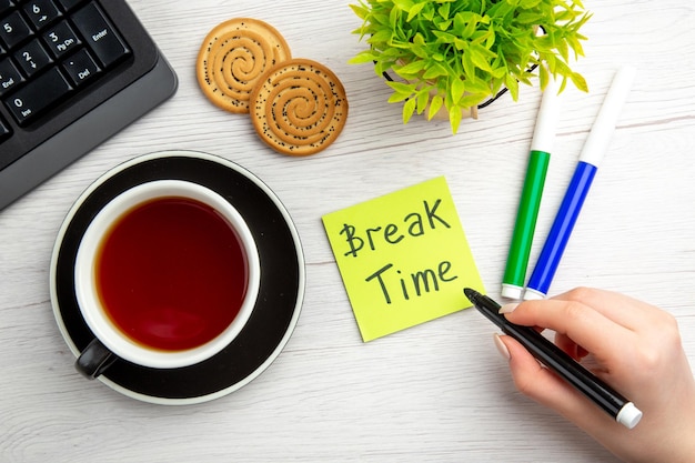 Top view cup of tea with written motivation notes on white background sweet business keyboard female job worker office