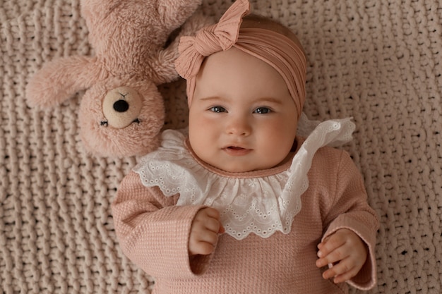 Top view cute baby with stuffed animal