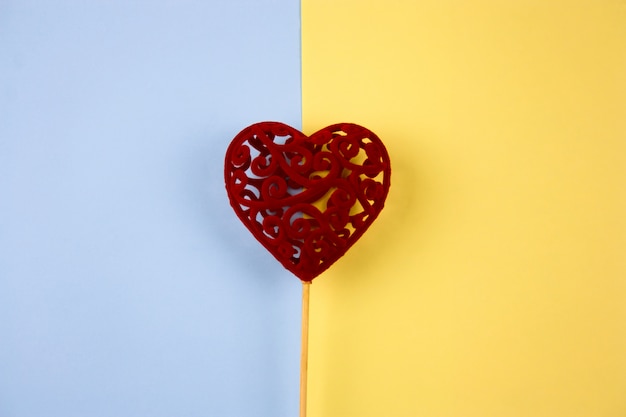 Top view cute red  heart on a blue and yellow background
