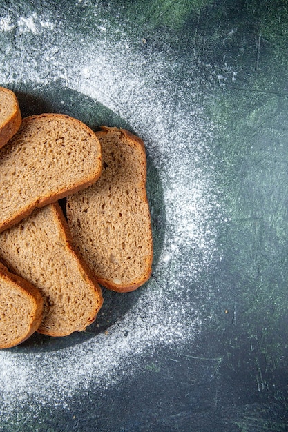 Top view dark bread loafs on dark desk