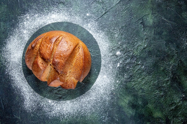 Top view dark bread with flour on dark desk