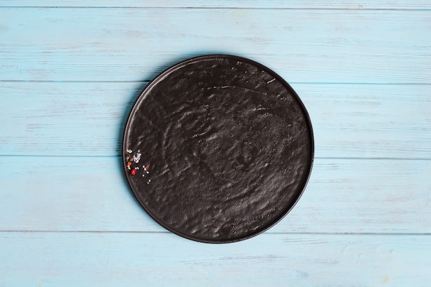 Top view of dark ceramic plate with spice and salt