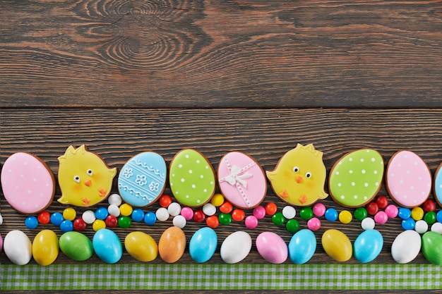 Top view of decorated easter cookies on wooden background