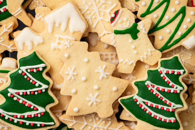 Top view of decorated green plain flavor gingerbread Christmas tree cookie with copy space, concept of holiday celebration.