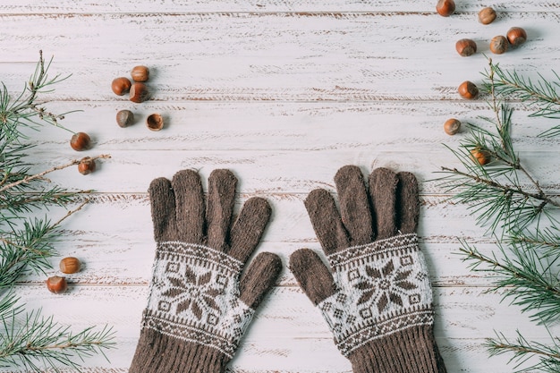 Top view decoration with gloves on wooden background