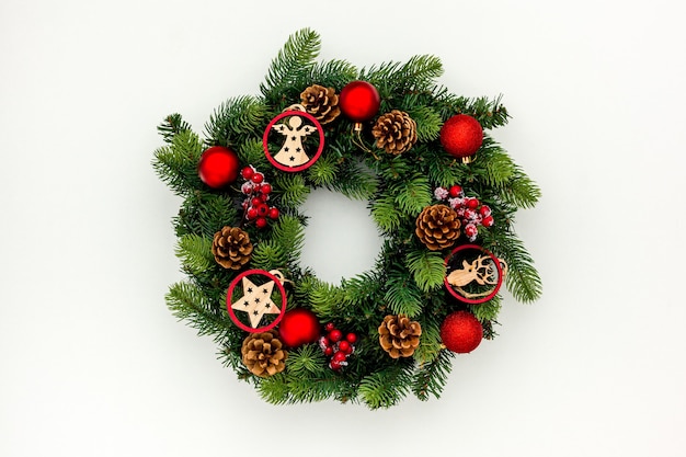 Top view of decorative festive wreath with red a Christmas toys isolated