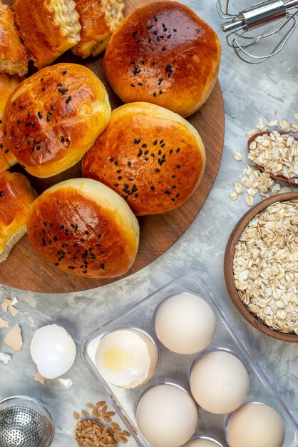 top view delicious buns with pastries cereals and eggs on white background dough pie fruit cook milk color pastry bake