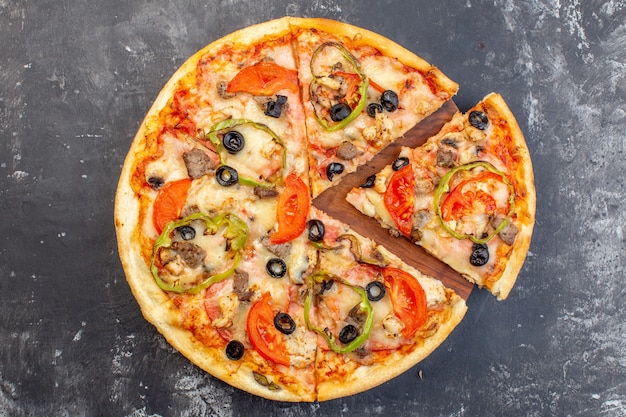 Top view delicious cheese pizza sliced and served on gray surface