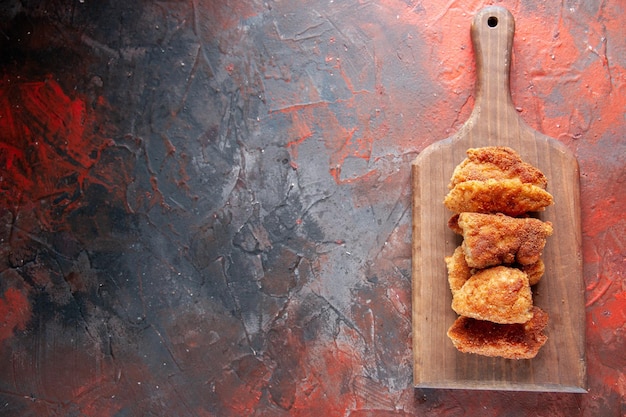 Top view delicious chicken wings on cutting board dark background meal dinner food meat salad lunch fries burger sandwich free space