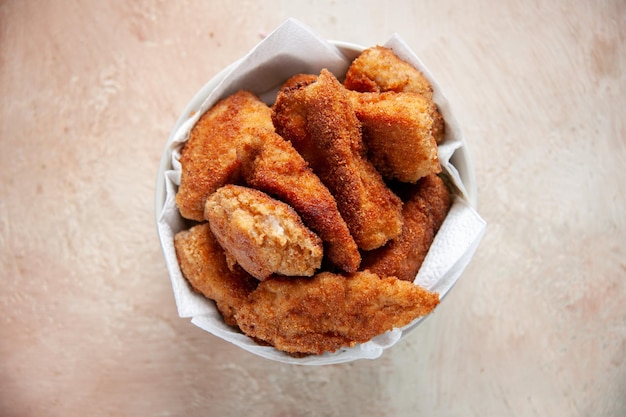 Top view delicious chicken wings inside plate with napkins on light background meat food burger sandwich horizontal meal