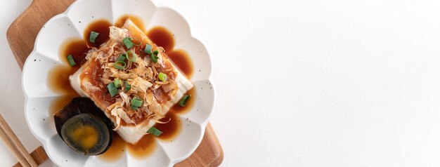 Top view of delicious Chilled tofu and century egg food with soy sauce and bonito flakes topping in Taiwan