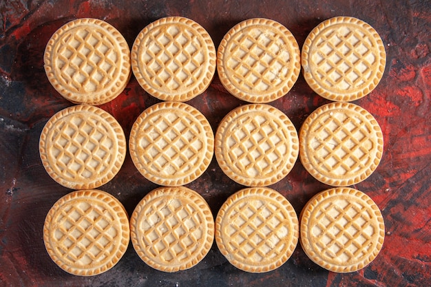 Top view of delicious cookies arranged in rows on mix colors background with free space