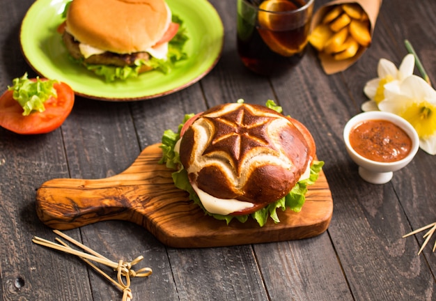 Top view of delicious hamburger, with vegetables,  on a wooden table