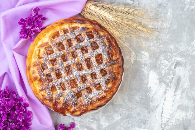 top view delicious jelly pie on white background flower purple cake biscuit dough dessert tea sugar