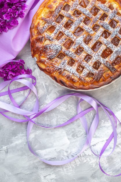 Top view delicious jelly pie on white background flower purple cake biscuit sweet dessert tea sugar dough