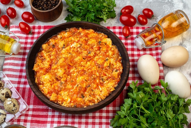 Top view delicious omelette with fried tomatoes around fresh vegetables on a white background morning breakfast bread milk lunch