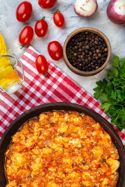 Top view delicious omelette with fried tomatoes around fresh vegetables on white background morning breakfast milk lunch