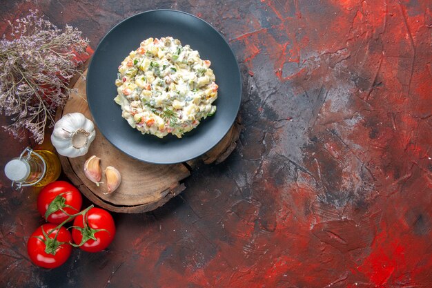 top view delicious russian salad with fresh red tomatoes on dark surface