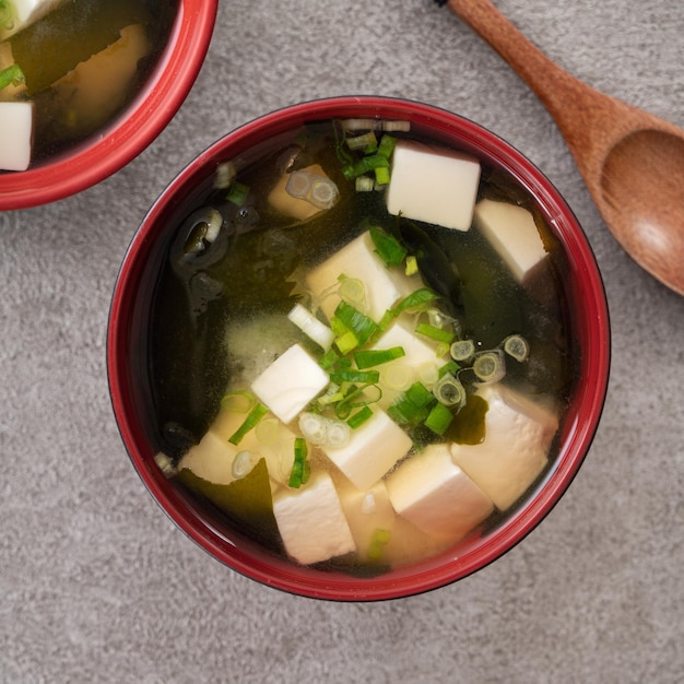 Top view of delicious savory Japanese miso soup in a black bowl for eating