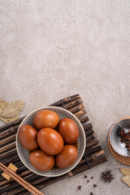 Top view of delicious traditional Taiwanese famous food tea eggs with in a bowl on gray table background