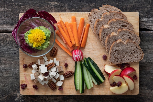 Top view of delicious vegan appetizer served on wooden board