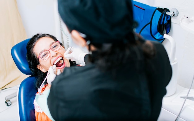 Top view of dentist doing dental checkup patient checked by dentist close up of dentist with patient dentist doing root canal treatment on patient