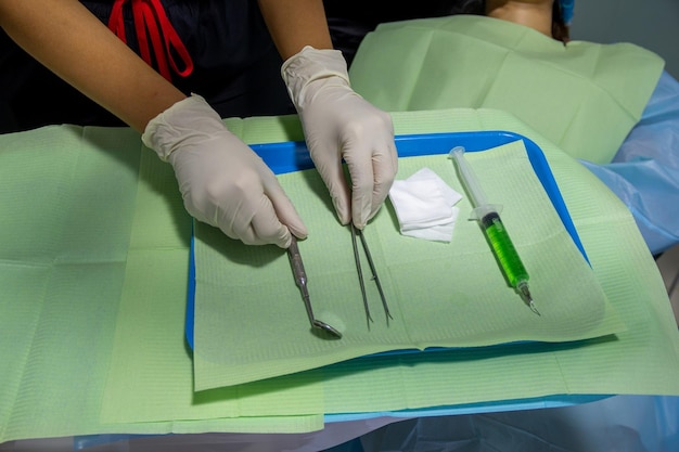 Top view of a dentist with sterile gloves placing elements to\
perform a vocal checkupx9