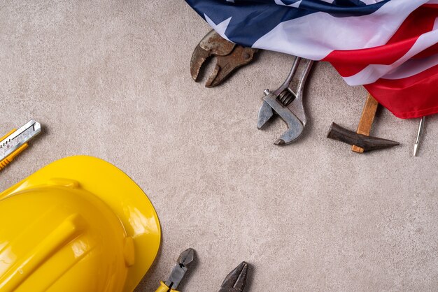 Top view design concept of american labor day with working tools on gray table background