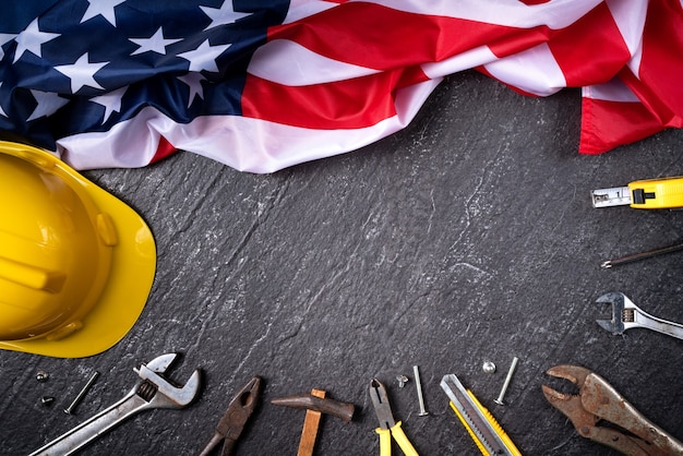 Photo top view design concept of american labor day with working tools on slate table background.