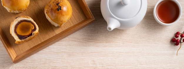 Top view design concept of Moon cake yolk pastry, mooncake for Mid-Autumn Festival holiday on wooden table background