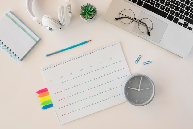 Top view desk calendar and laptop