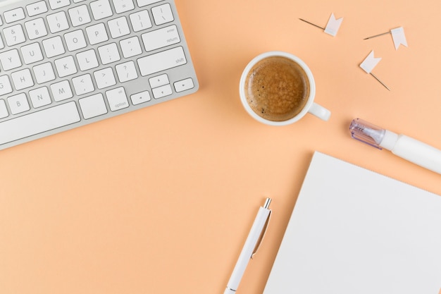 Top view of desk with keyboard and coffee