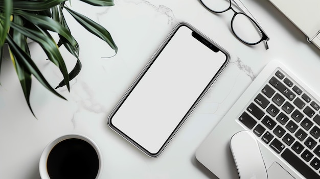 Photo top view of a desk with a laptop a smartphone a cup of coffee a mouse glasses and a plant