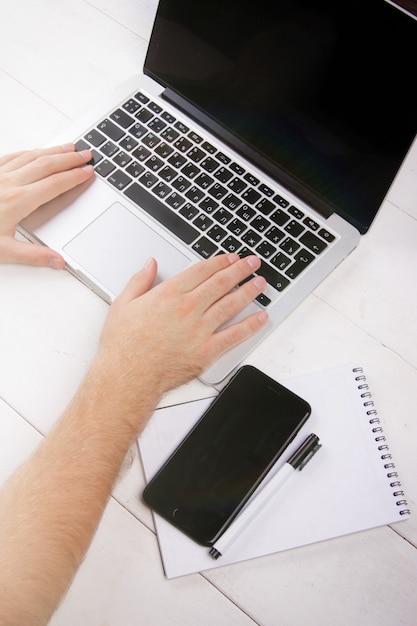 top view of the desktop and mens hands