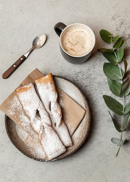 Top view of dessert with powdered sugar and coffee