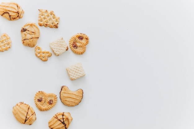 Top view different cookies on table top Flat lay of various cookies on white background