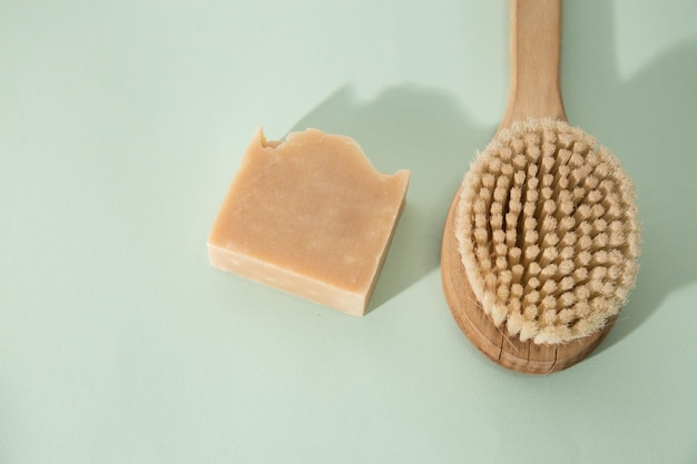 Top view of different handmade soap bars on mint background