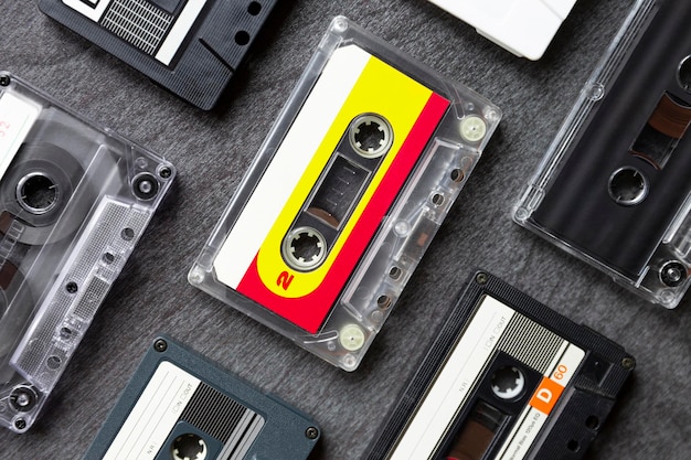 Top view of different old cassette tapes on dark gray background Music icon of the 80s and 90s Close up