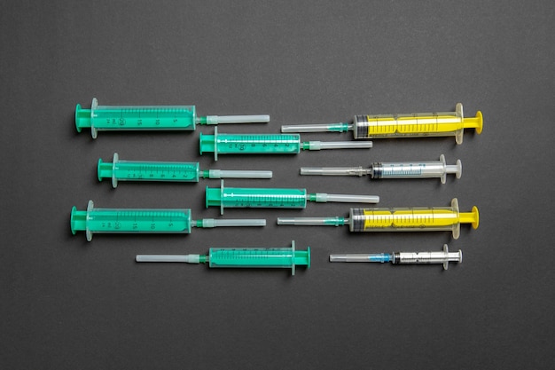 Top view of different syringes at black